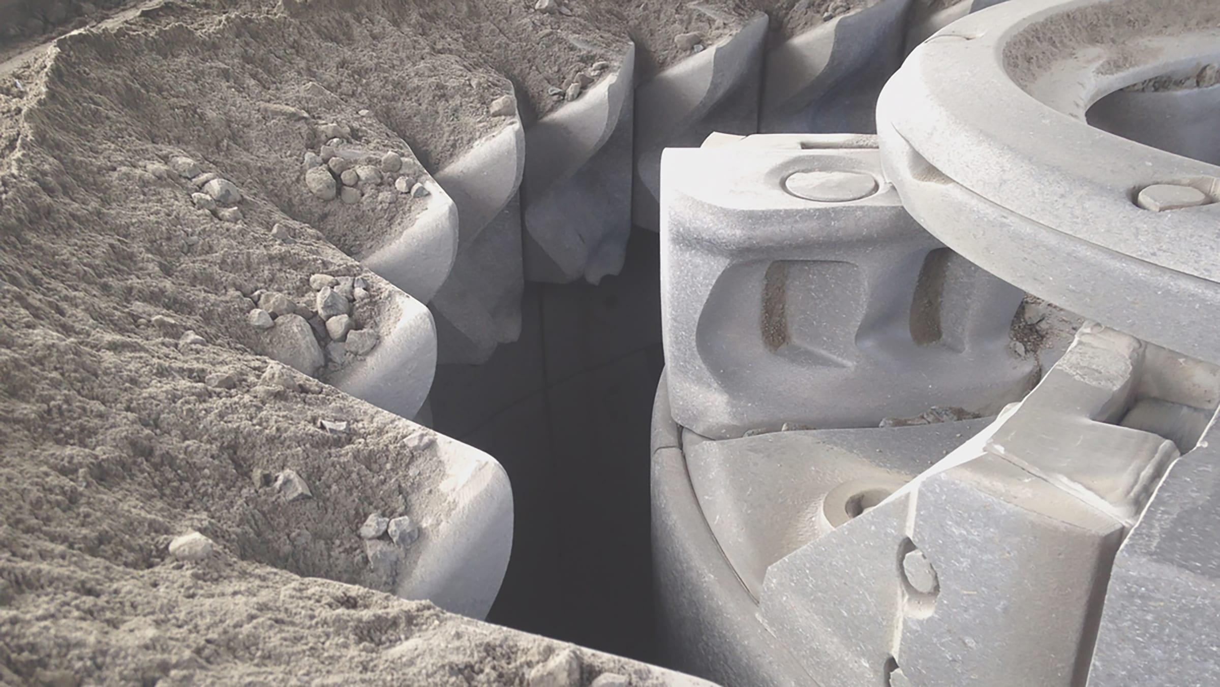 Inside a VSI rotor after a run: wear shoes and feed disk packed with rock dust and fines.
